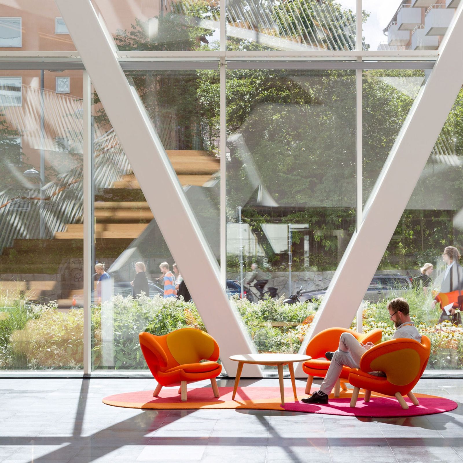 Swedbank: Orange armchairs under angled white columns