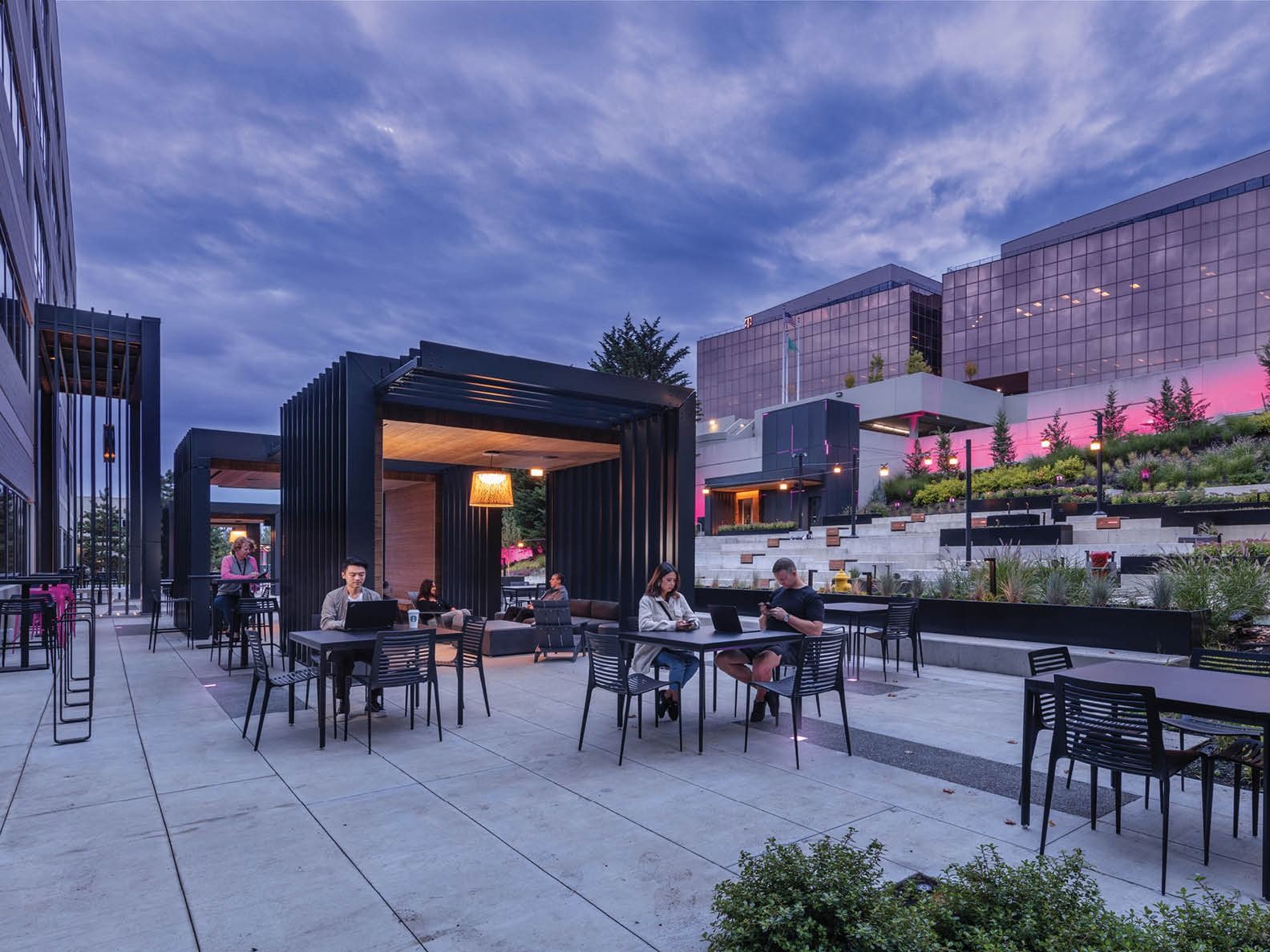 T-Mobile US: Courtyard with tables and a dark pavilion at dusk