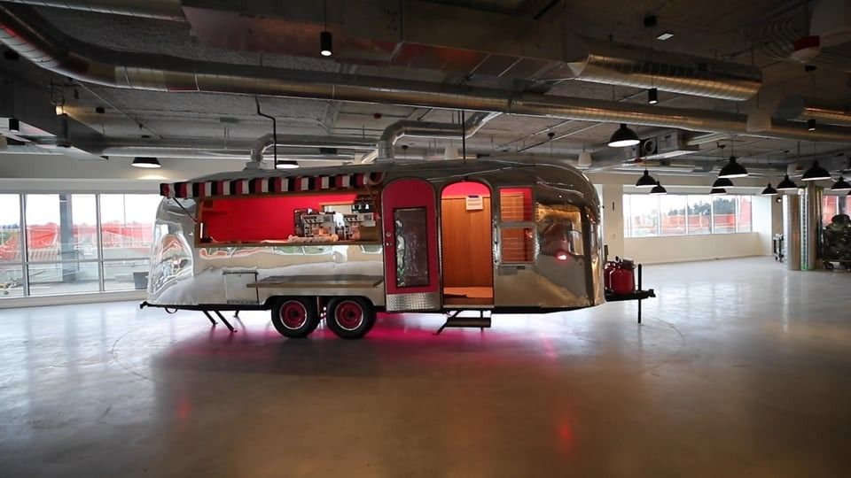 T-Mobile US: Vintage Airstream trailer serving as a food kiosk on an open floor