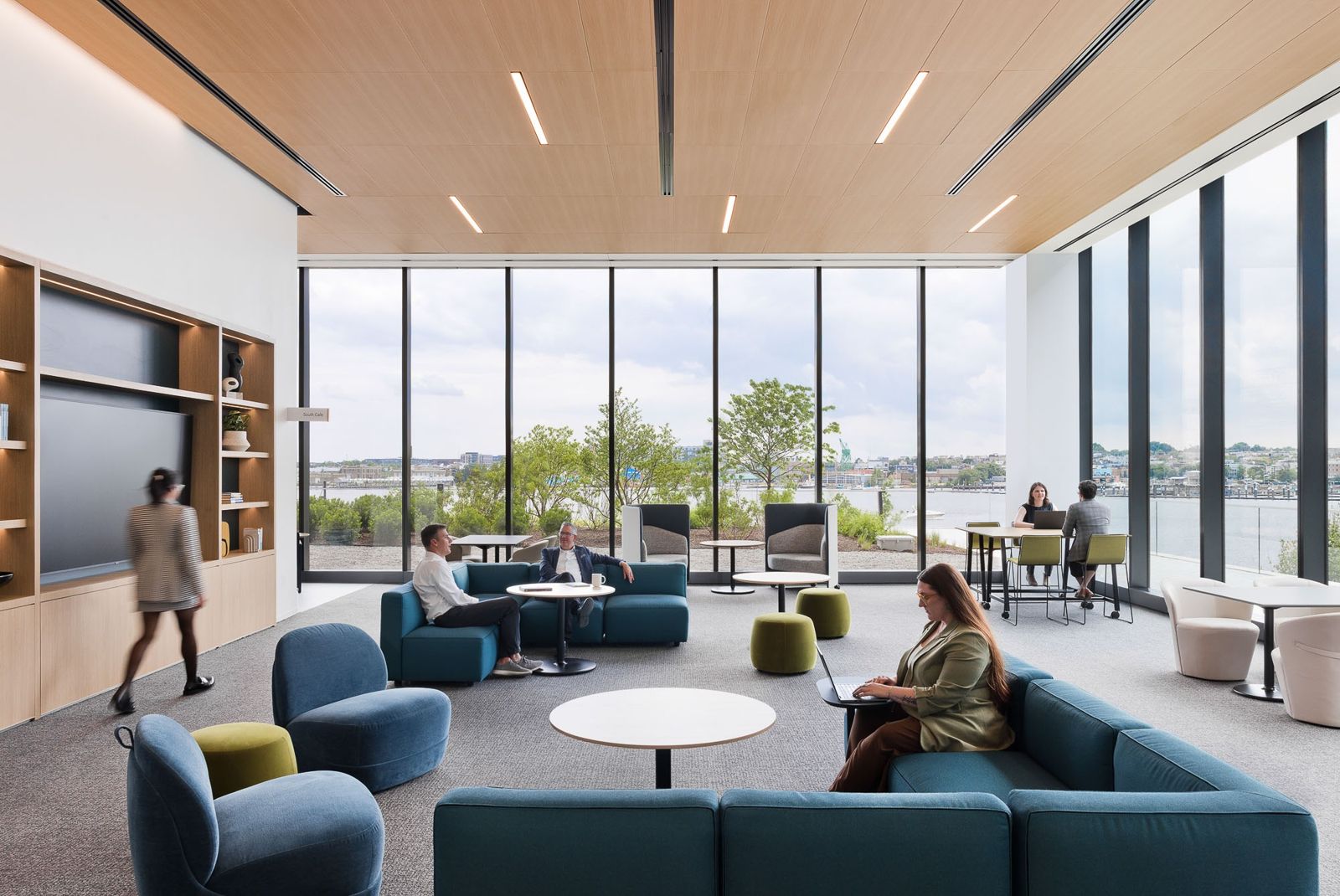 T. Rowe Price: A bright double-height lounge with blue sofas and floor-to-ceiling windows