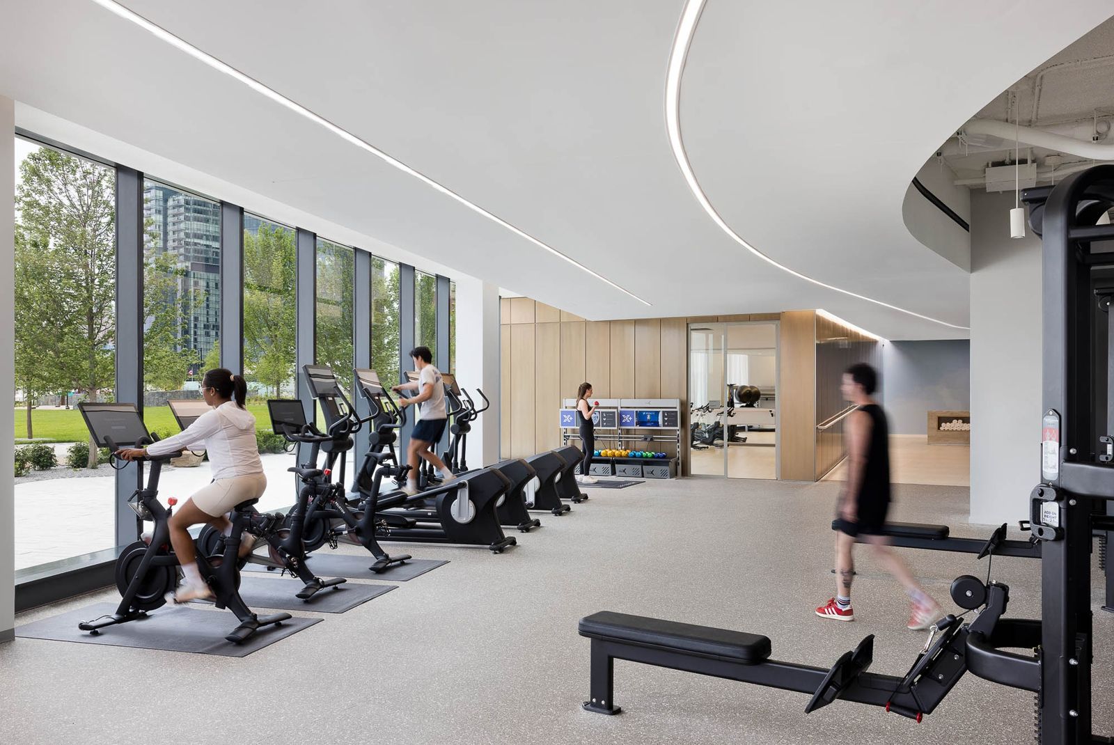 T. Rowe Price: A fitness center with bikes and rowing machines next to big windows