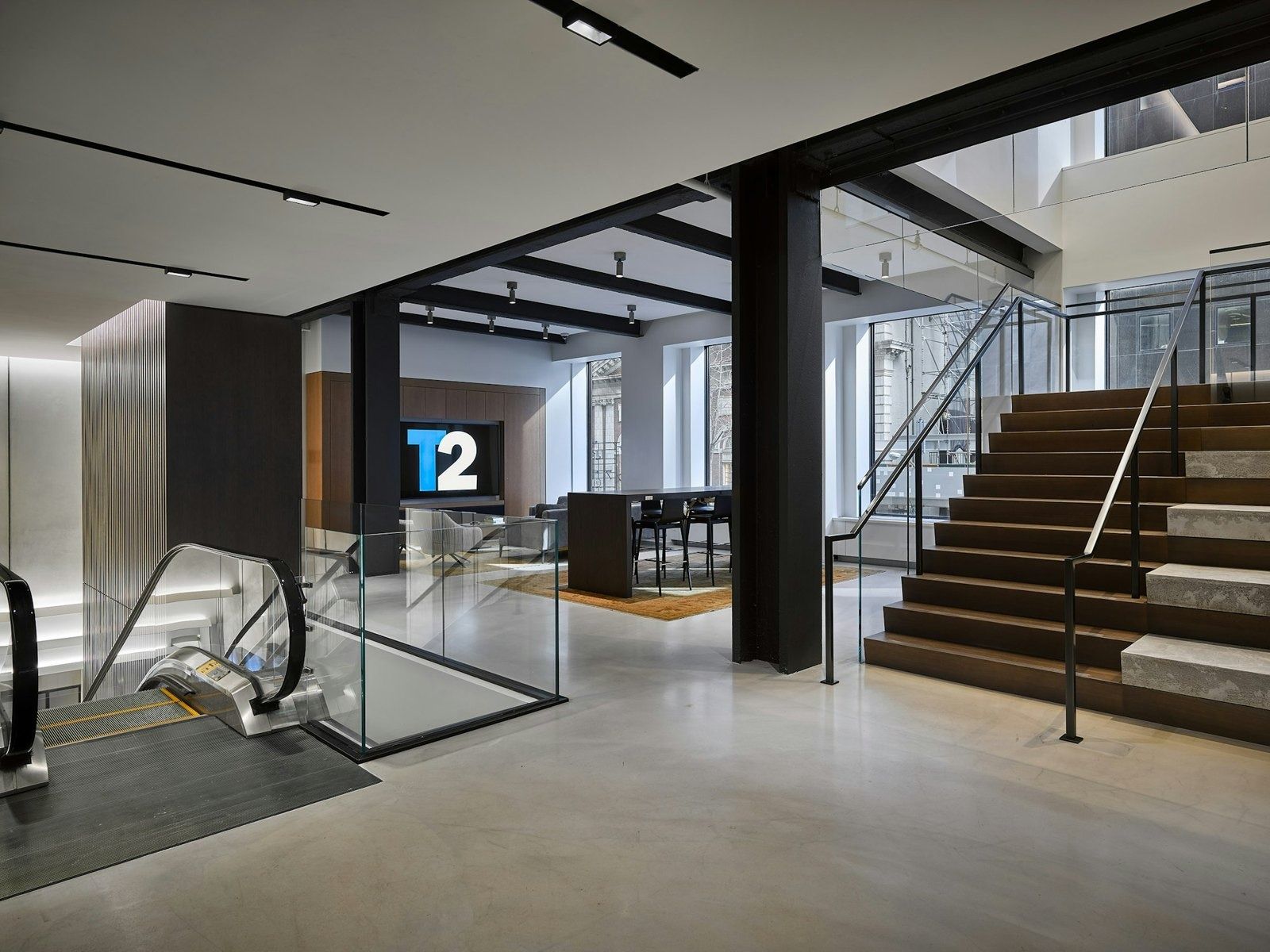 Take-Two Interactive: Double-height space with an escalator, a broad staircase and steel columns