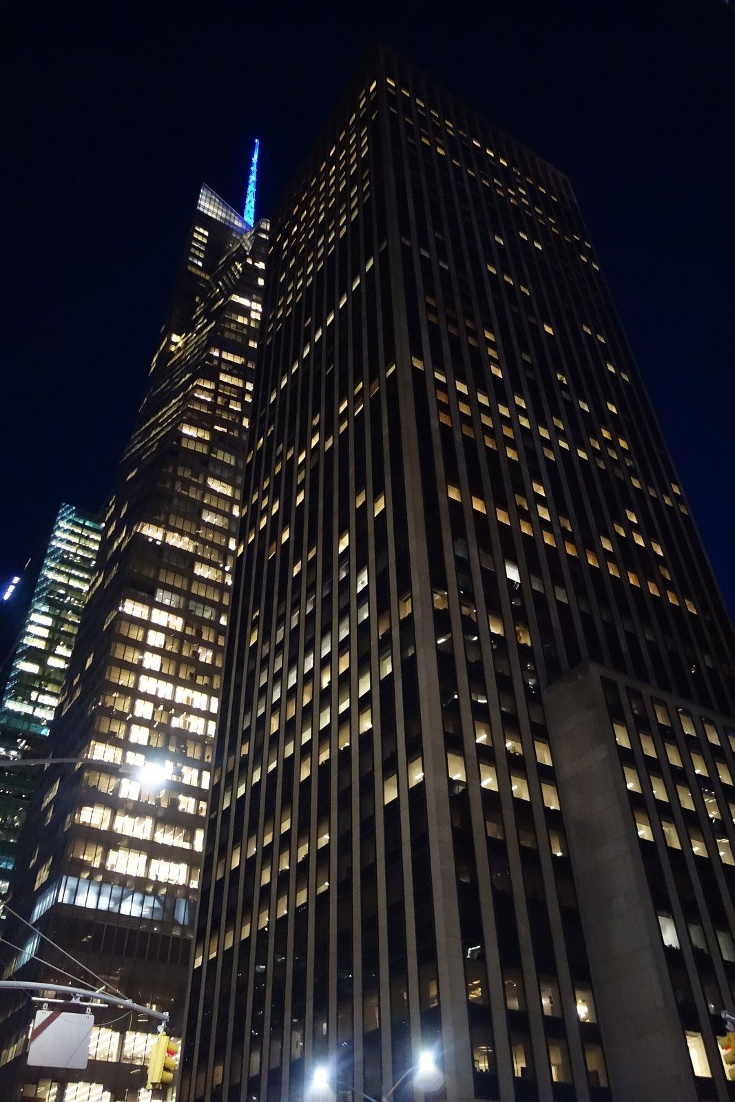 Take-Two Interactive: Office tower with lit windows photographed from street level at night