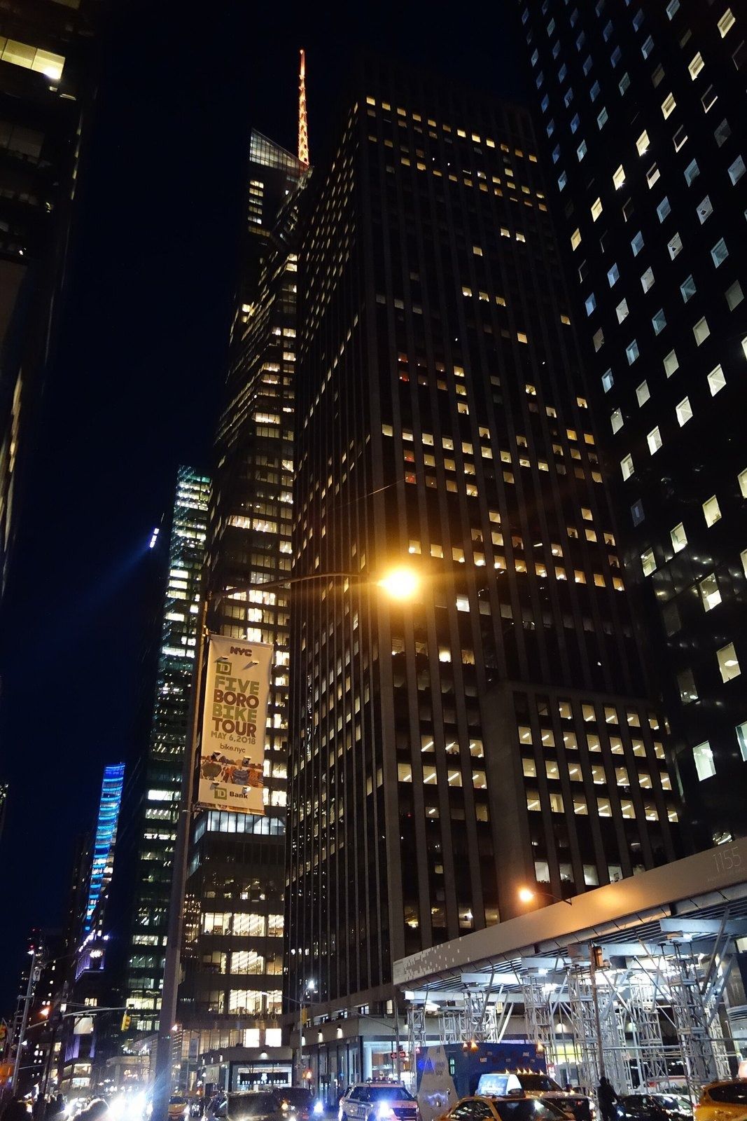 Take-Two Interactive: Tower and neighbouring buildings lit up along an avenue at night