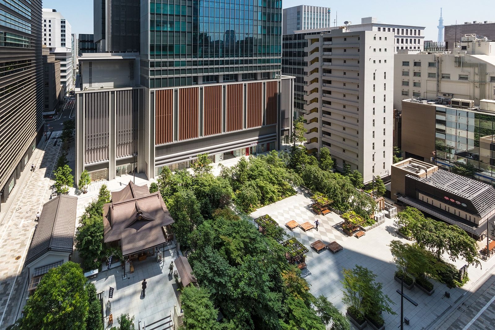 Aerial view of the headquarters with timber-louvred lower floors and a tree-filled garden