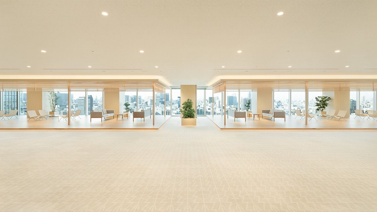 Takeda: Empty wood-floored hall with windows on two sides
