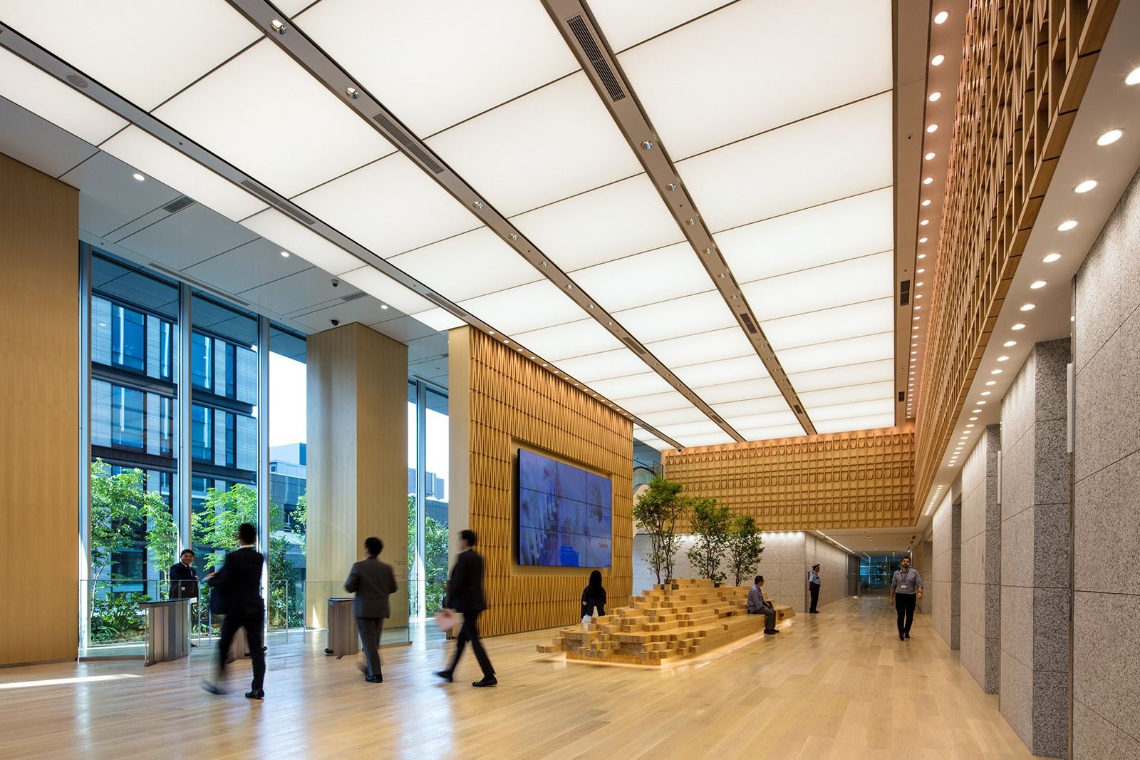 Takeda: Long lobby with a wooden lattice ceiling, a planted display and screens