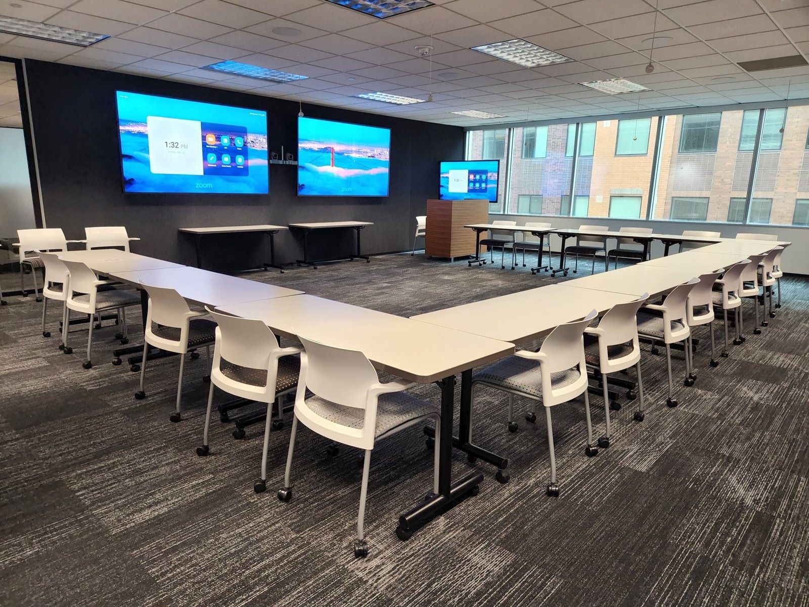 Target: Large conference room with three screens