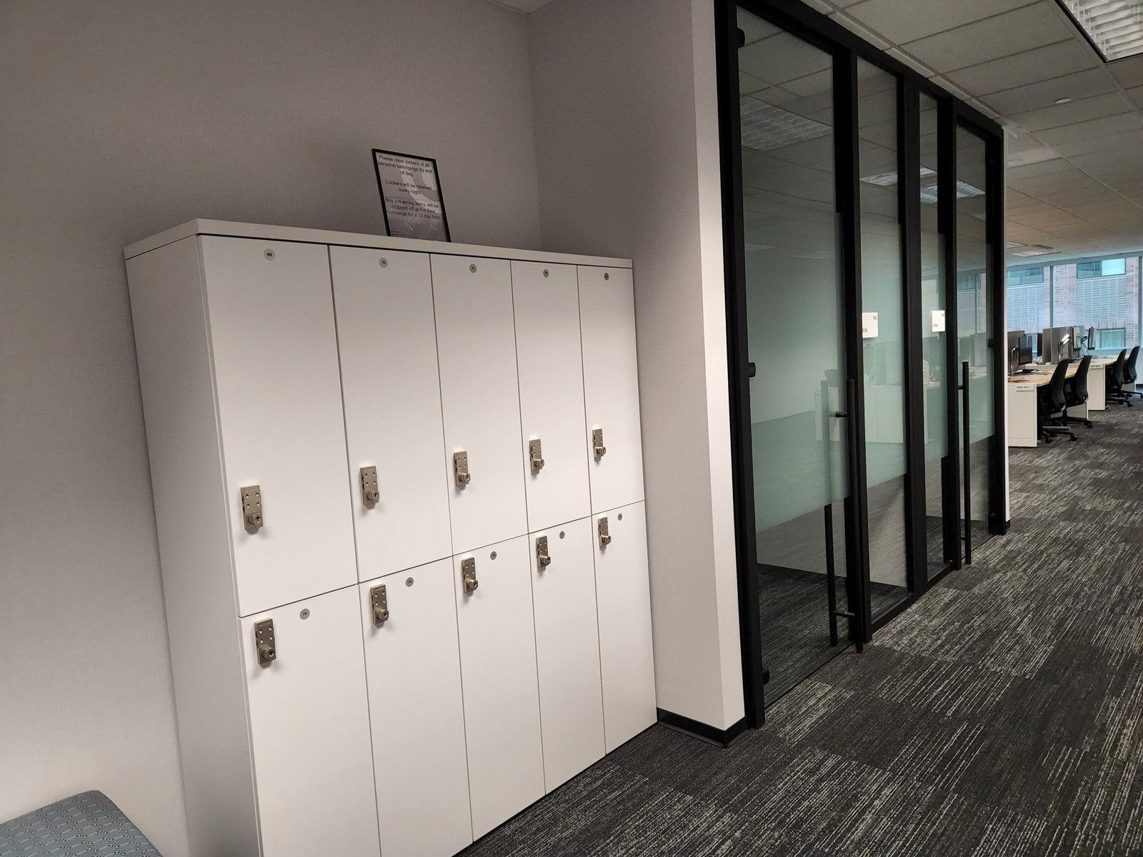 Target: White lockers beside glass meeting rooms