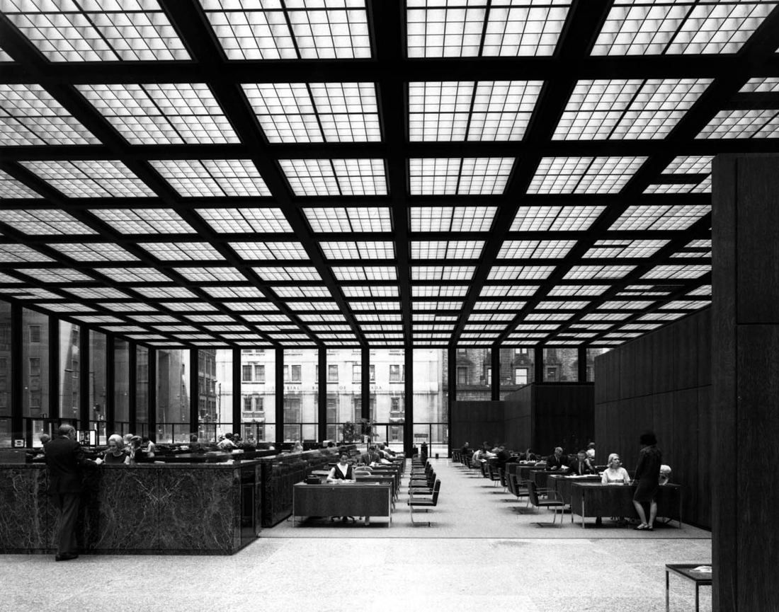 TD Bank Group (The Toronto-Dominion Bank): Black-and-white photo of a large hall with a grid ceiling, marble counters and rows of desks