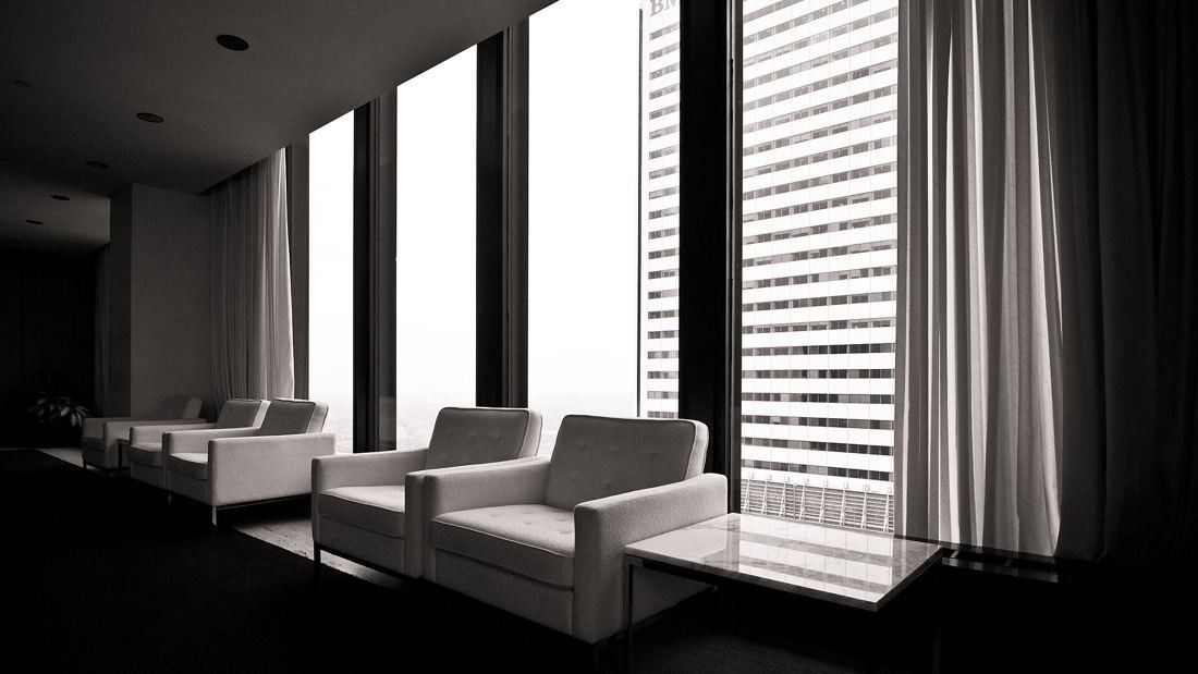 TD Bank Group (The Toronto-Dominion Bank): Black-and-white view of white armchairs by tall windows
