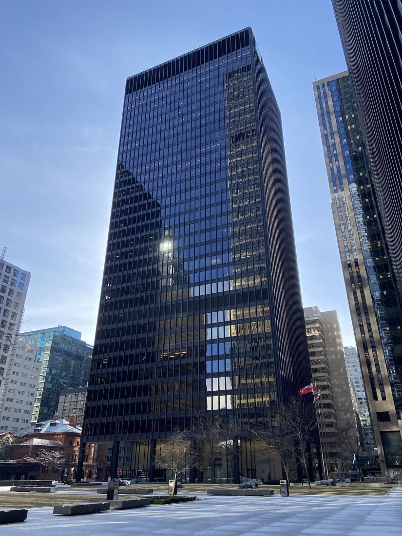 TD Bank Group (The Toronto-Dominion Bank): Black tower with a plaza in front under a blue sky