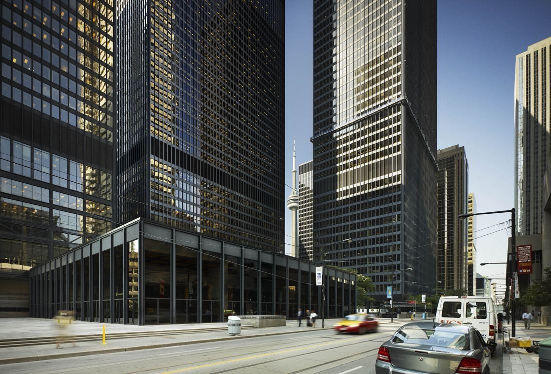TD Bank Group (The Toronto-Dominion Bank): Black towers and a glass pavilion along a city street