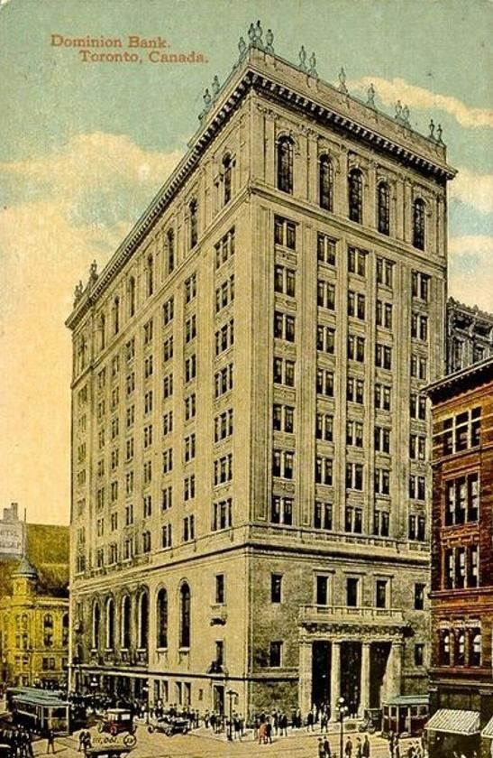 Coloured postcard of a tall early skyscraper bank building on a busy street corner