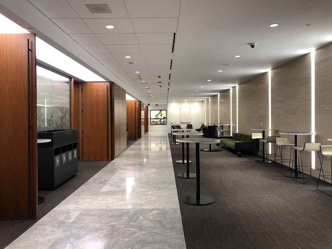 TD Bank Group (The Toronto-Dominion Bank): Corridor with stone floor, wood walls and high-top tables