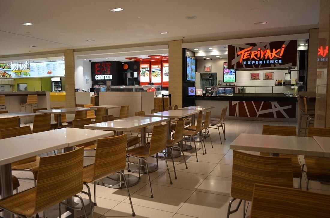 TD Bank Group (The Toronto-Dominion Bank): Food hall with tables and chairs in front of food counters