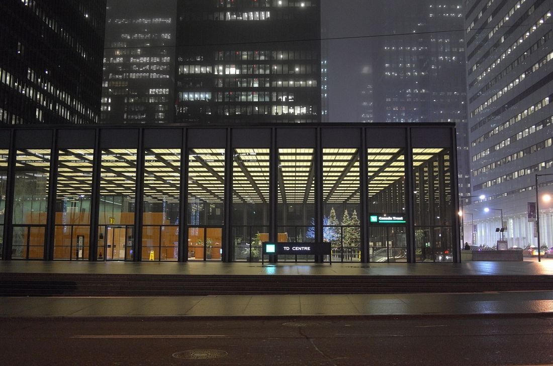 TD Bank Group (The Toronto-Dominion Bank): Glass pavilion lit at night with a coffered ceiling