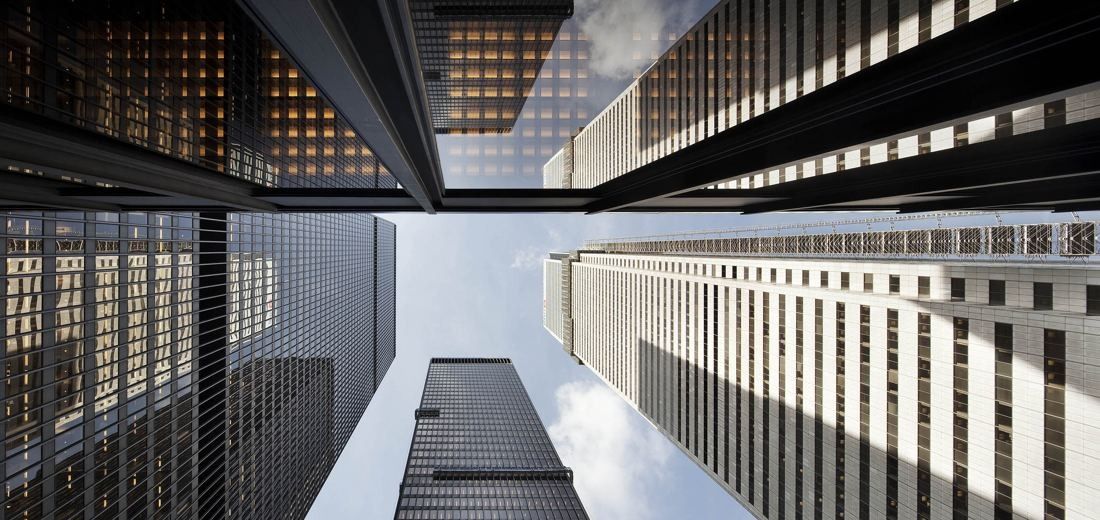 TD Bank Group (The Toronto-Dominion Bank): Looking straight up between black towers with a strip of sky