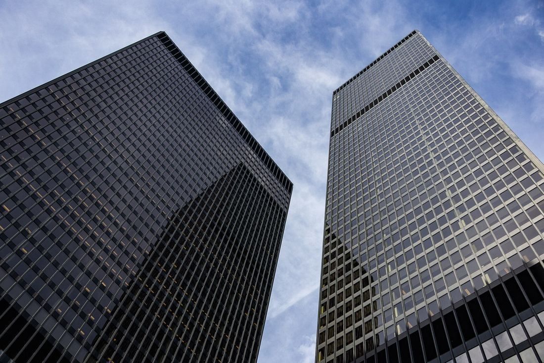 TD Bank Group (The Toronto-Dominion Bank): Two dark towers seen from below against a blue sky