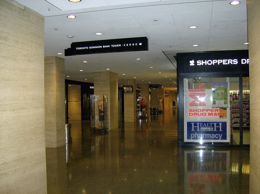 TD Bank Group (The Toronto-Dominion Bank): Underground shopping corridor with stone columns and shop fronts