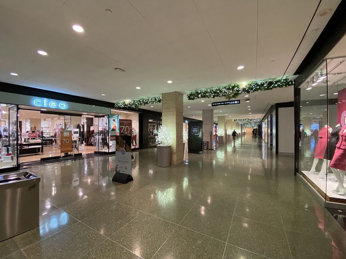 TD Bank Group (The Toronto-Dominion Bank): Wide shopping concourse with polished floor and shop windows