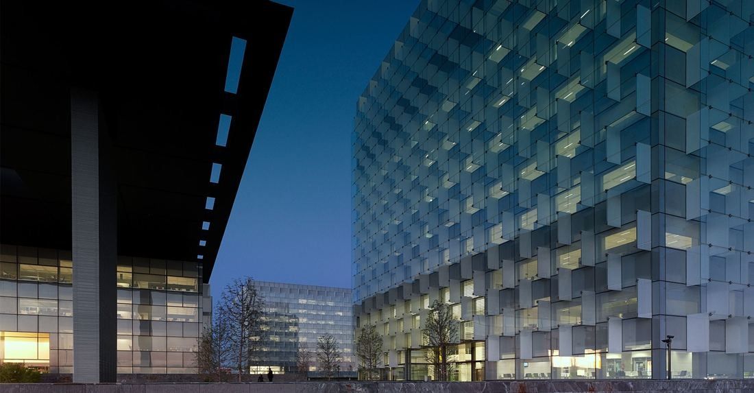 Telefónica: Lit glass facade under a dark canopy at blue hour