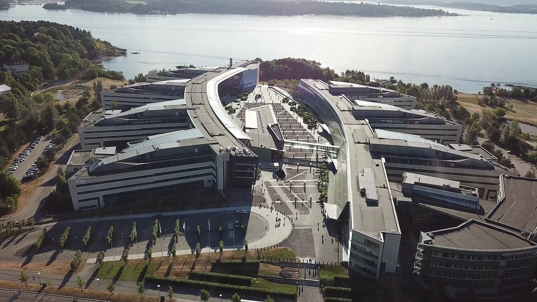 Telenor: Aerial view of a large curved office complex beside the fjord