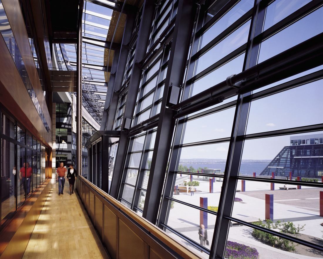 Telenor: Long corridor along tall slanted windows looking out over the site