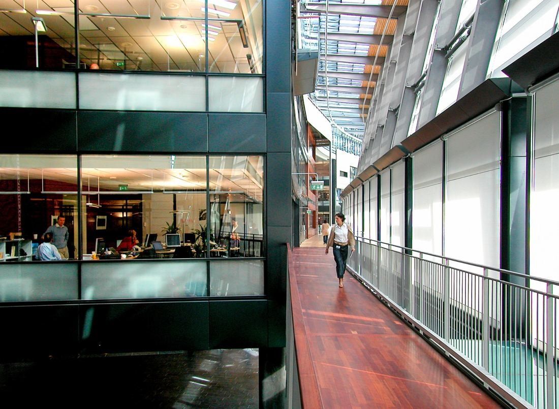 Telenor: Wooden walkway beside offices with glass walls under a sloping glass roof