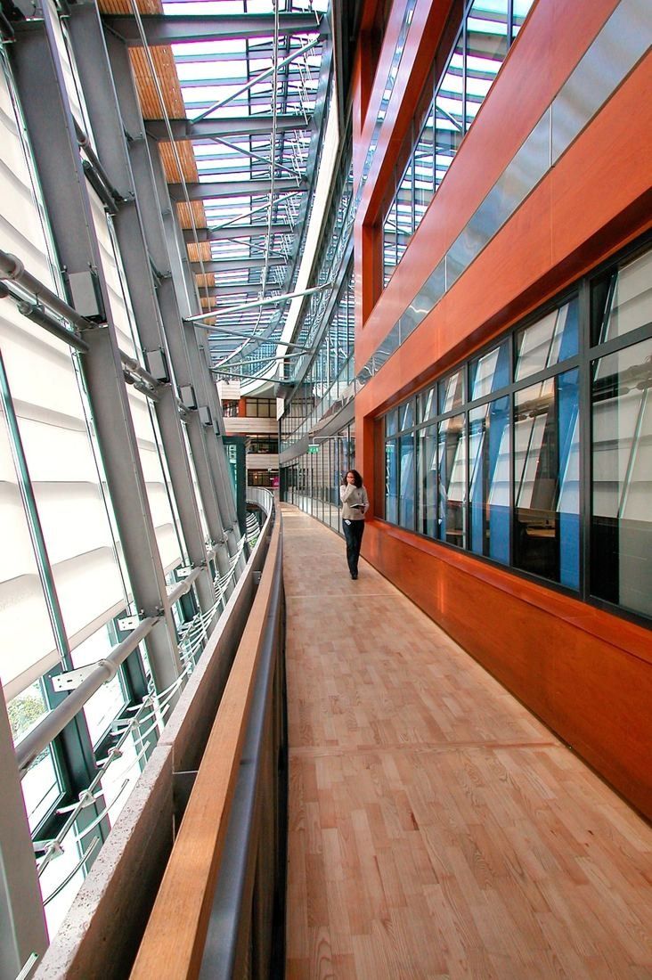 Telenor: Wooden walkway between a red wall and a tall glass facade