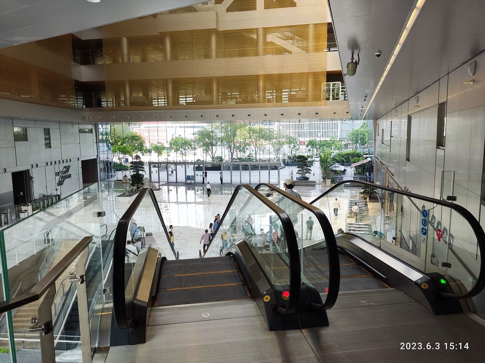 Tencent: Escalators leading out to a bright glass entrance