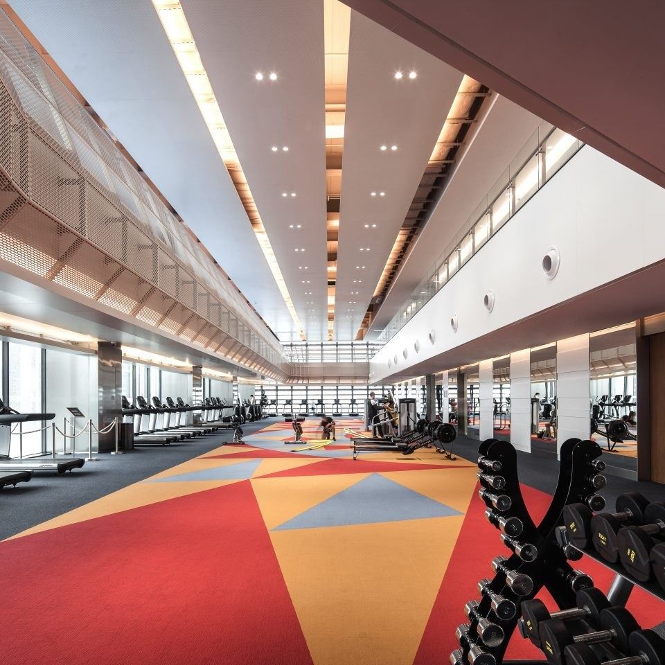 Tencent: Long gym with treadmills along the windows and a colourful floor