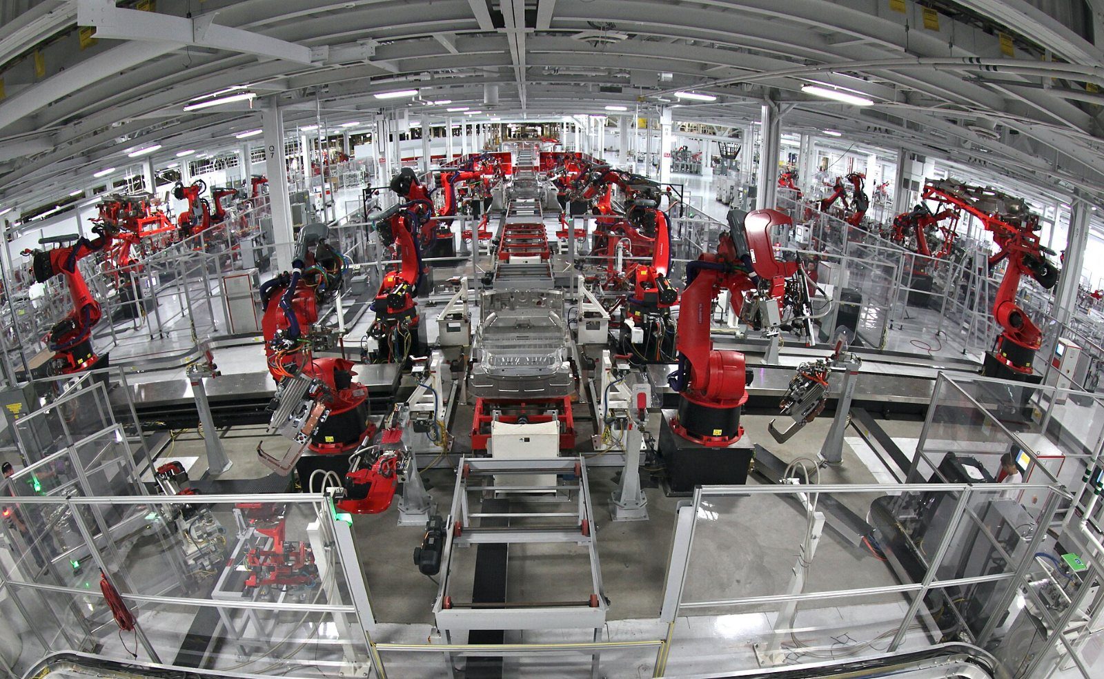 Rows of red robots on a factory floor