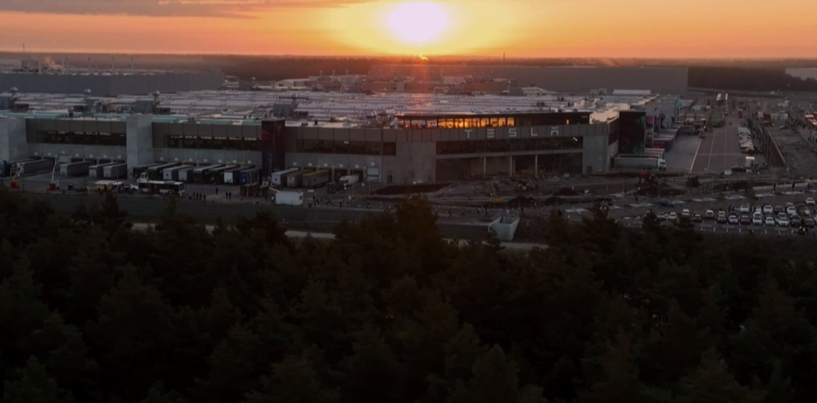 Factory at sunset seen from a drone