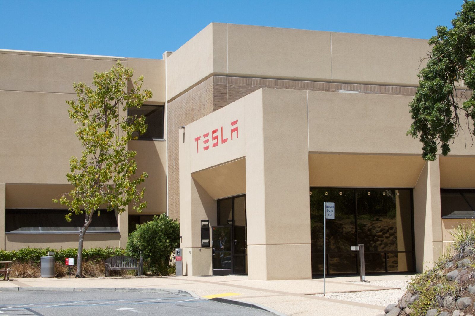 Beige building with a red TESLA sign