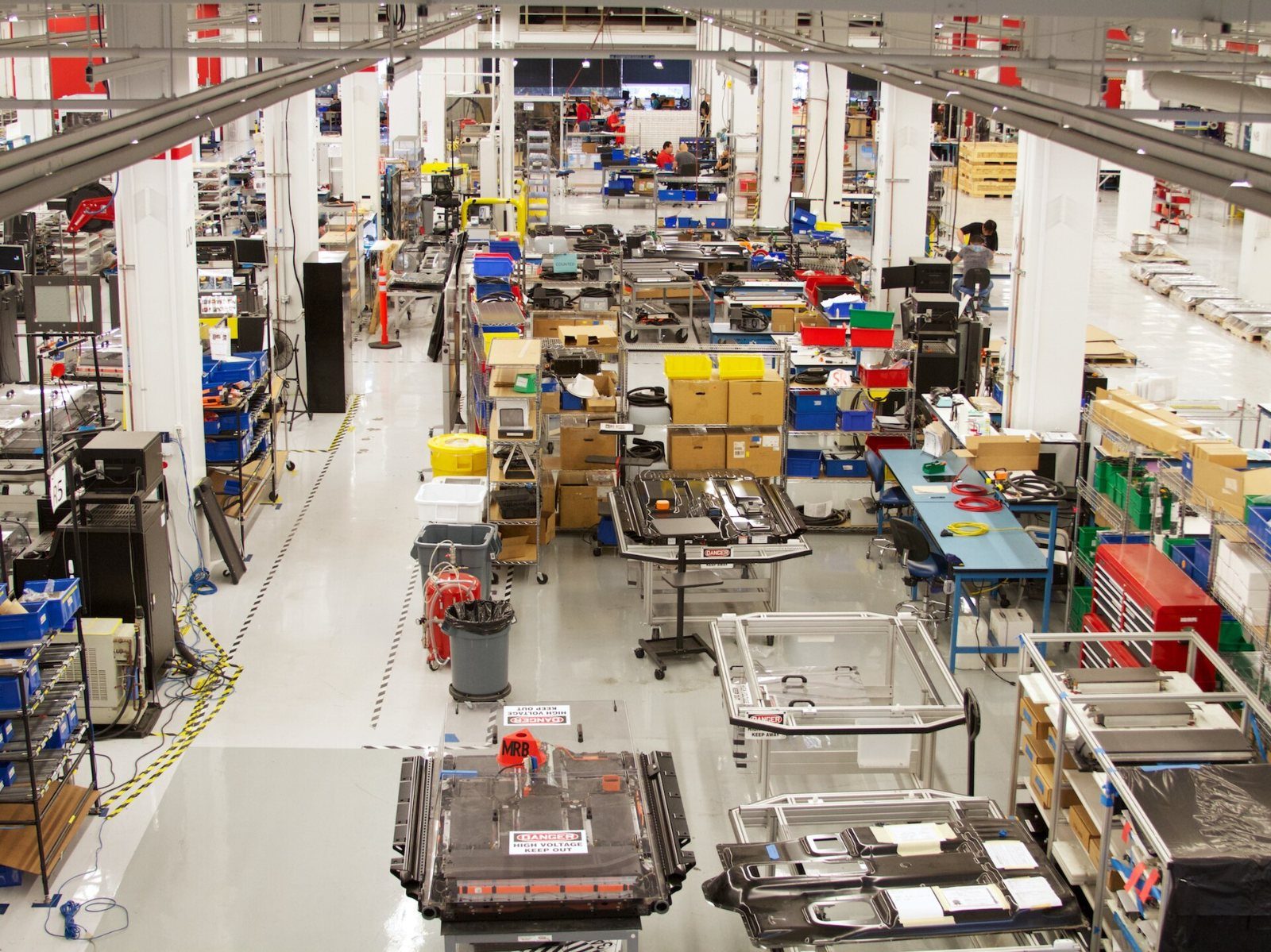 Tesla: Long view over workbenches and parts shelves