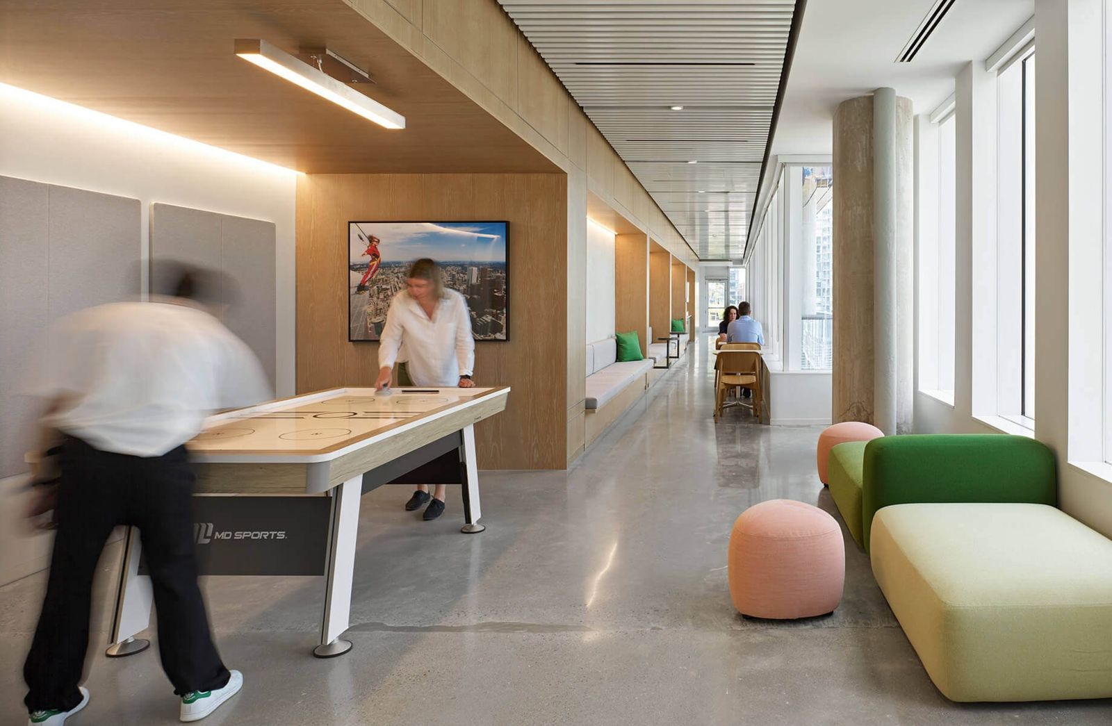 Thomson Reuters: A corridor lounge with a shuffleboard table and soft seats