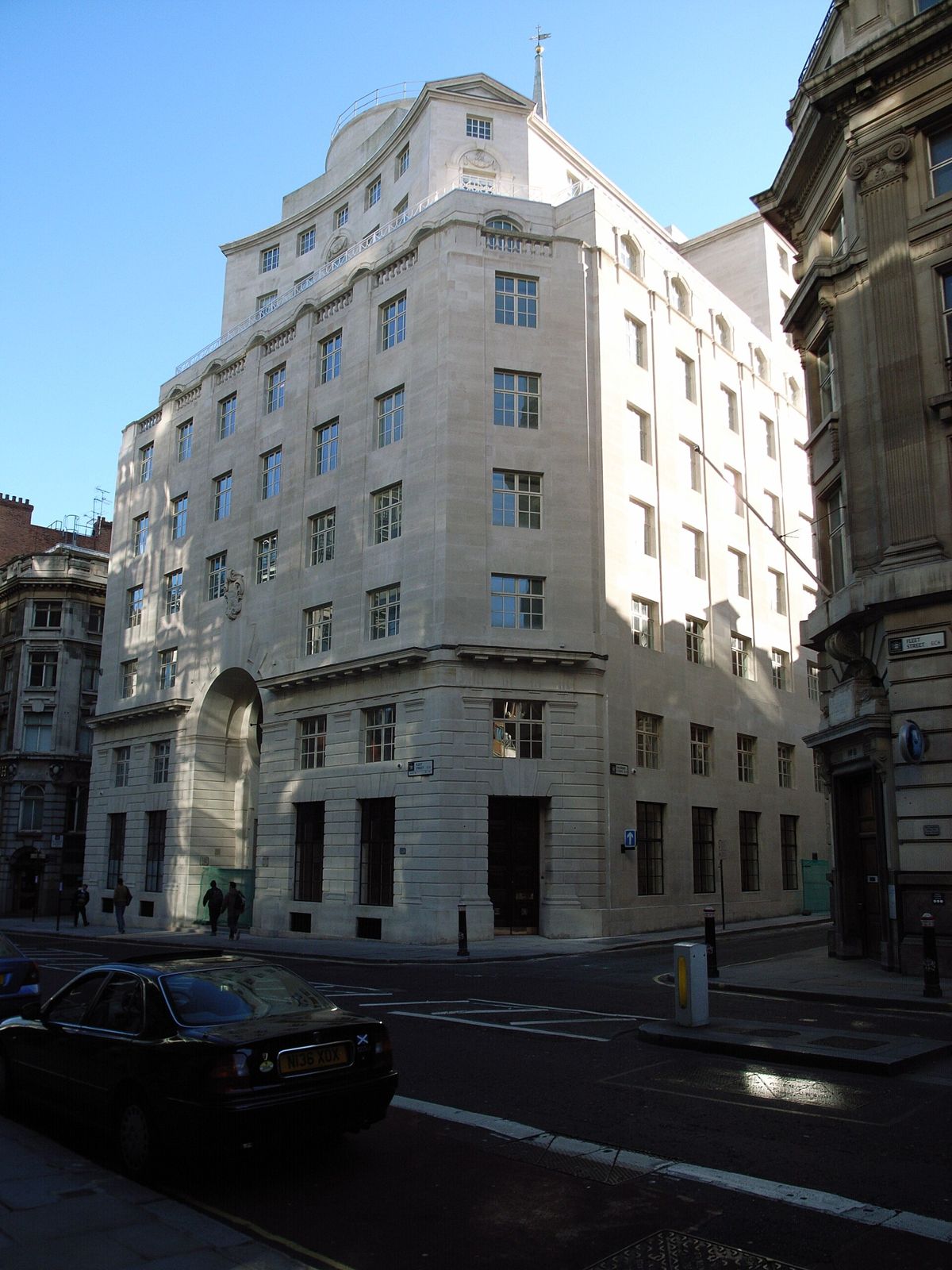 Thomson Reuters: A white stone office building seen from a quiet courtyard