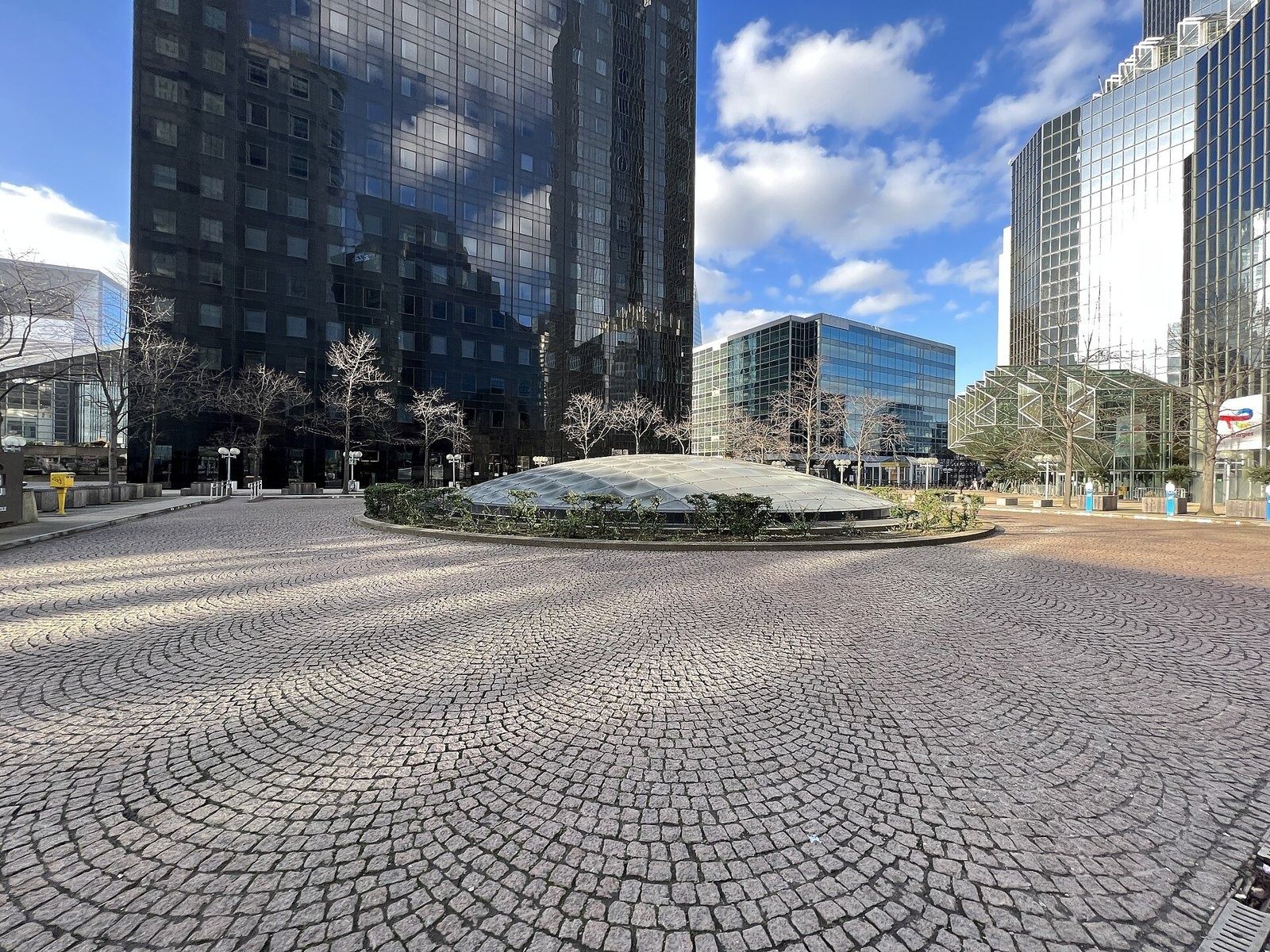 Cobbled plaza between glass towers