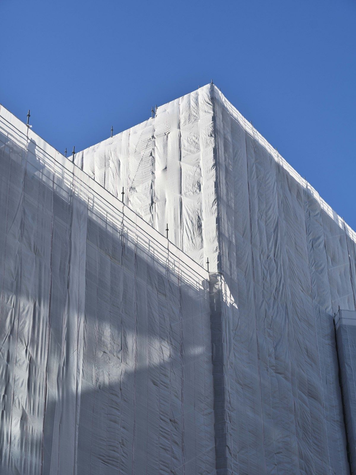 TotalEnergies: Concrete core rising against blue sky