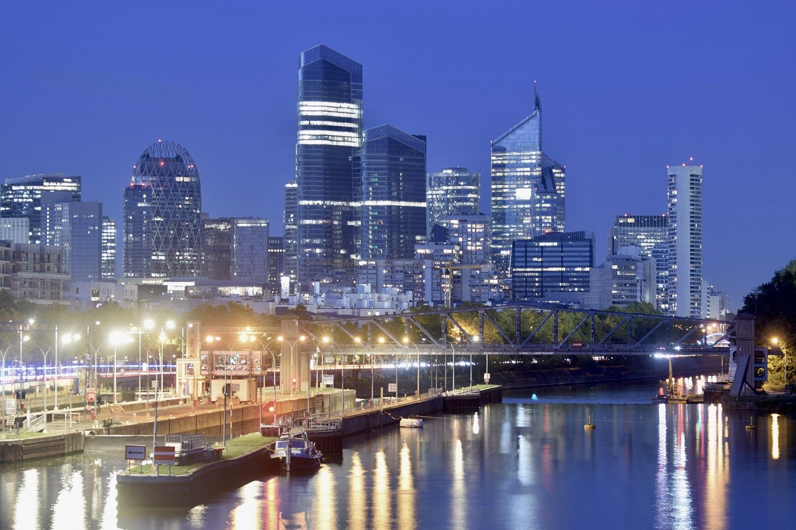 TotalEnergies: Lit skyline reflected in the river at night