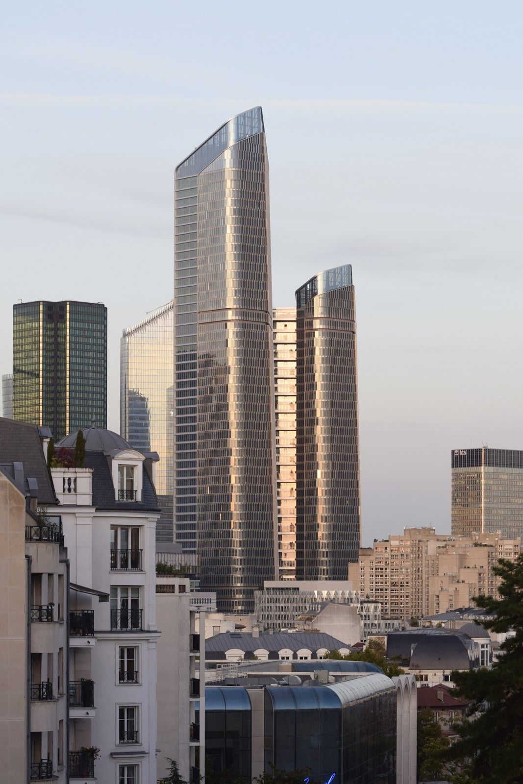 TotalEnergies: Twin towers beside an older building