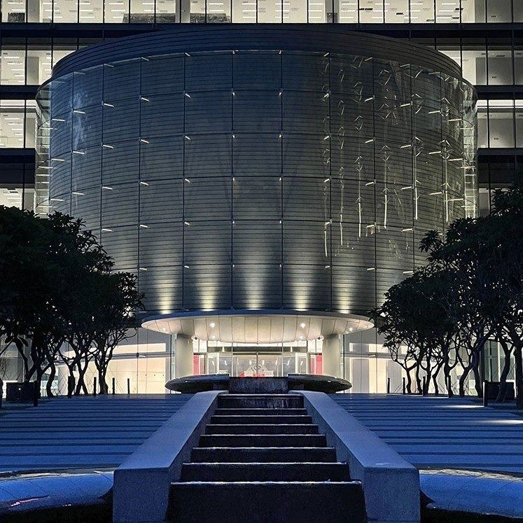 TSMC: The R&D Center's curved glass facade lit at night