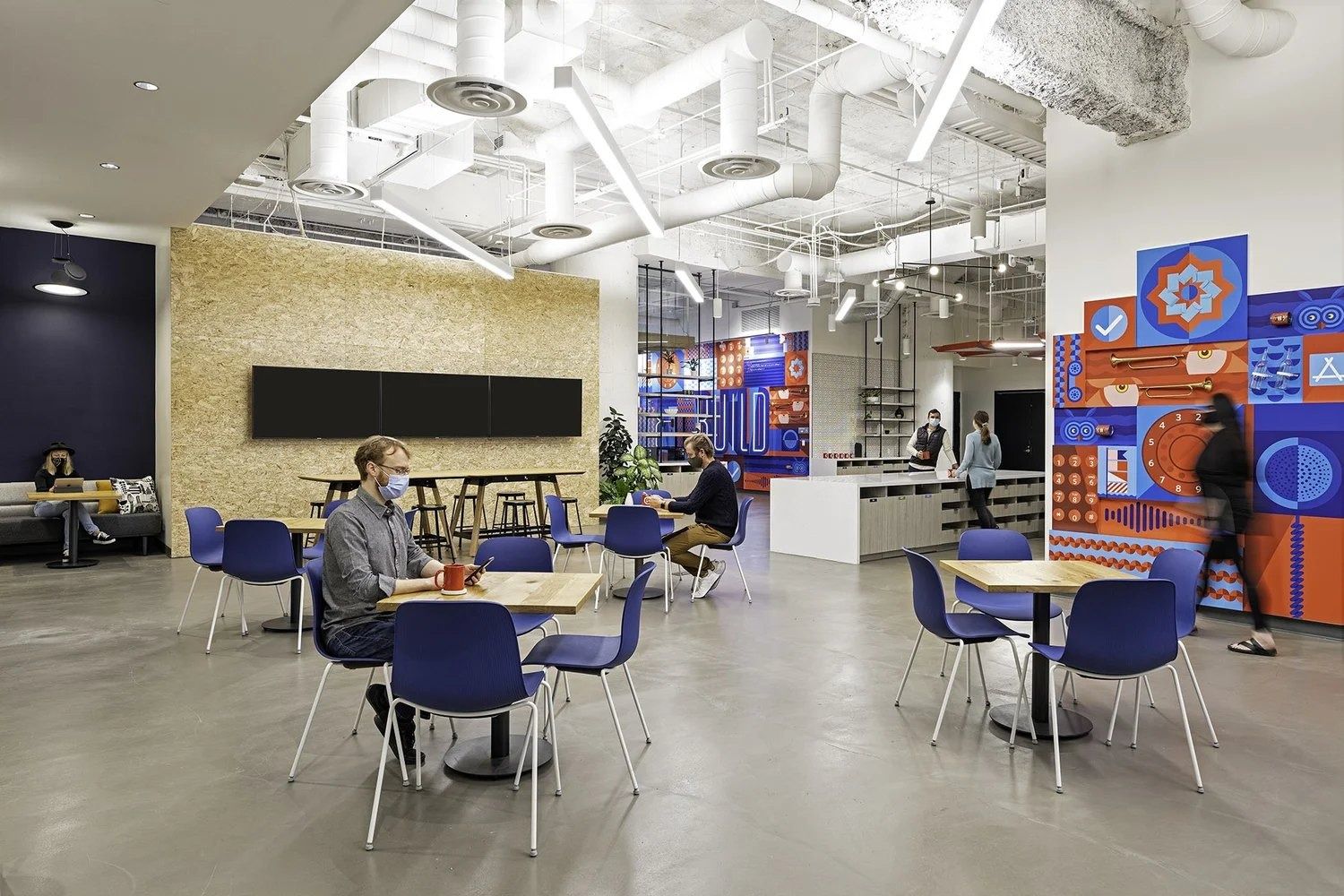 Twilio: Café tables beside a colourful wall