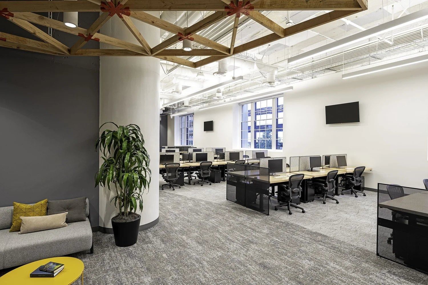 Twilio: Desk rows beside a lounge with a plant