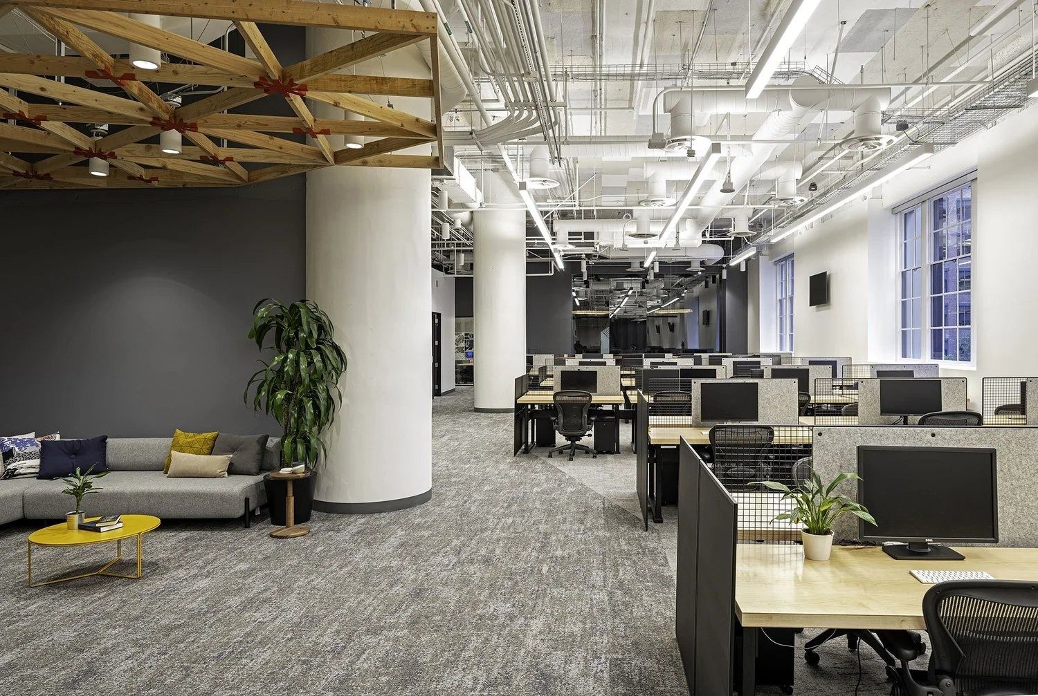 Twilio: Lounge with yellow tables next to desk rows