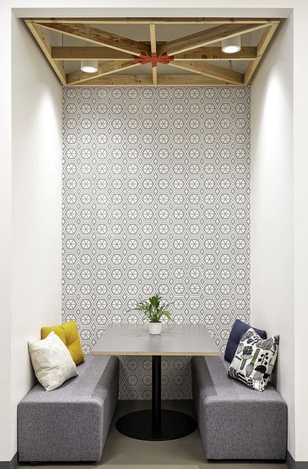 Twilio: Small booth with a patterned wall and cushions