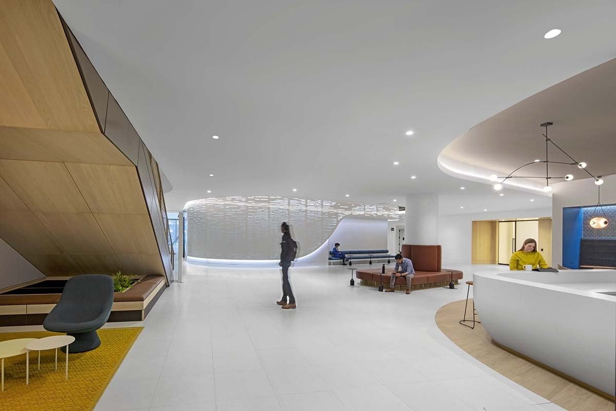 Uber: A curved white pre-function area with lounge seating