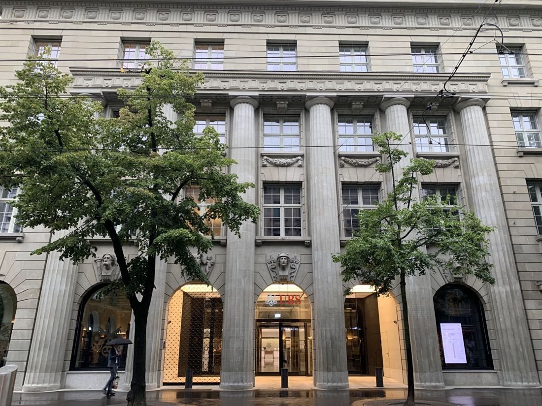 UBS: Stone bank façade with columns behind two street trees