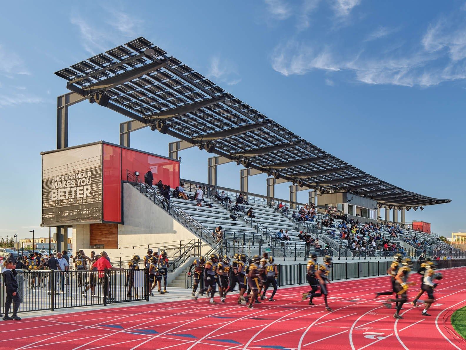 Under Armour: Covered stand with a solar canopy and a red running track with athletes in the distance